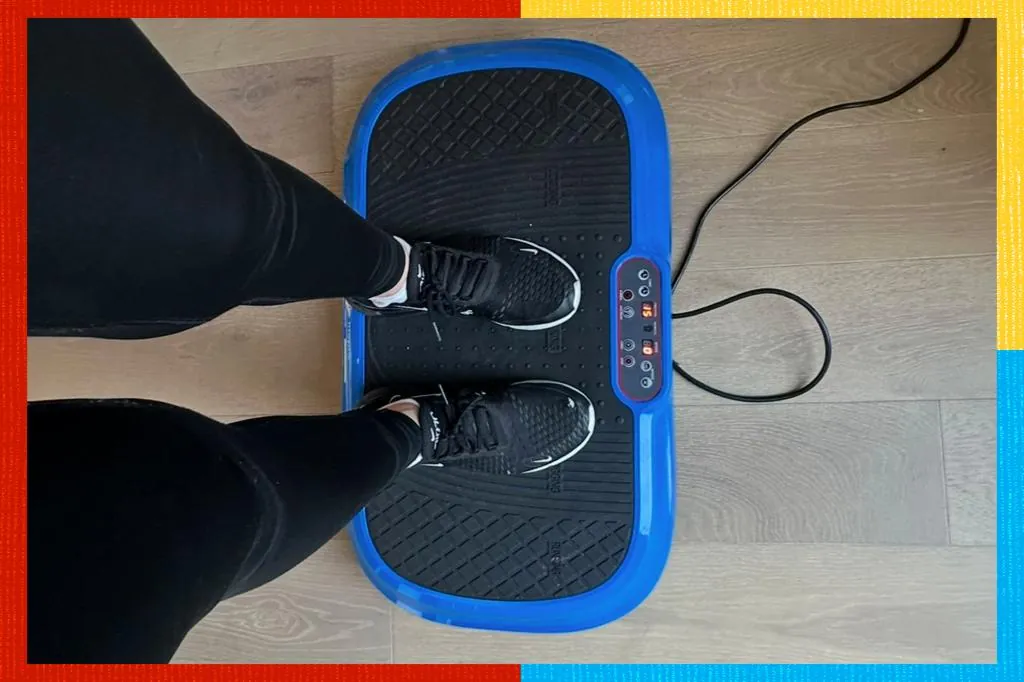 Idle vibration plate on wooden floor beside a folded towel