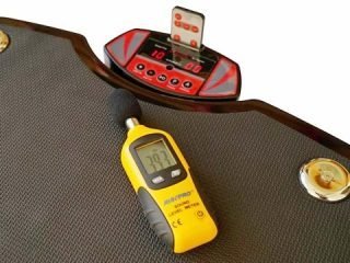 Vibration plate on a rubber mat in a bright home gym
