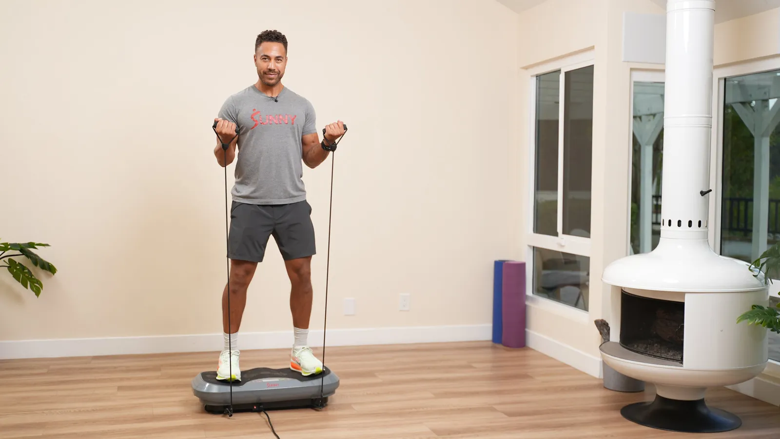 Vibration plate with sneakers beside it showing session timing at home