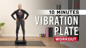 Woman balancing on a vibration plate during a ten minute workout at home